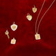 Still life image of Small Gold Initial Crest Charm with Stone and Strand solid gold jewelry