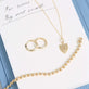 Still life image of Small Gold Initial Crest Necklace with Stone and Strand solid gold jewelry