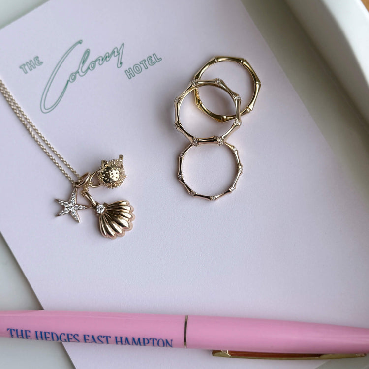 Still life image of Soft Inside Pufferfish Charm with Stone and Strand solid gold jewelry