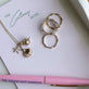 Still life image of Soft Inside Pufferfish Charm with Stone and Strand solid gold jewelry