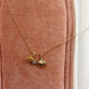Still life image of Soft Inside Pufferfish Charm with Stone and Strand solid gold jewelry