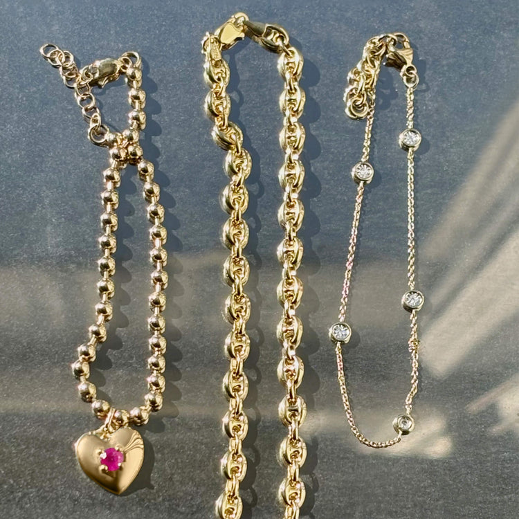 Still life image of Heart and Soul Ruby Bracelet with Stone and Strand solid gold jewelry