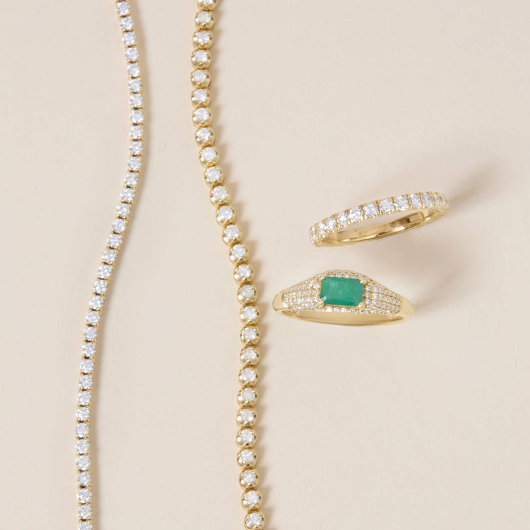 Still life image of Claudia Emerald Signet Ring with Stone and Strand solid gold jewelry