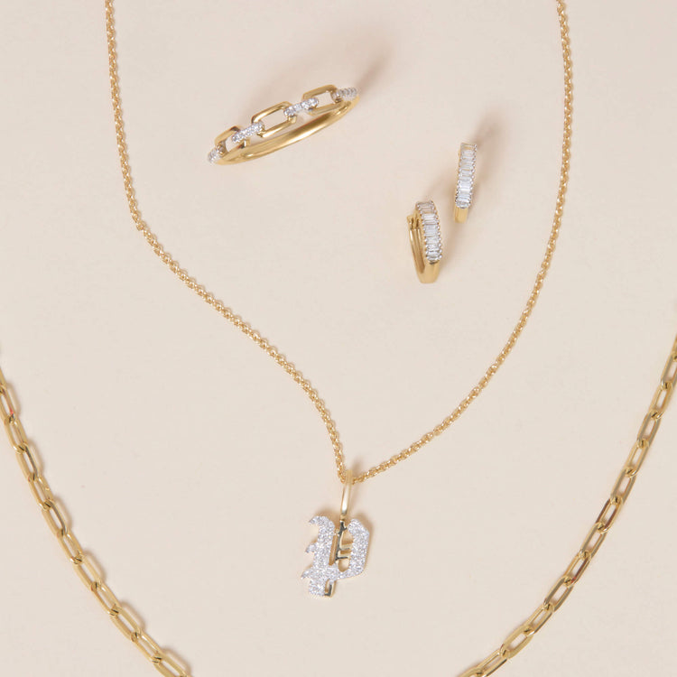 Still life image of Dainty Up And Down Baguette Diamond Huggies with Stone and Strand solid gold jewelry