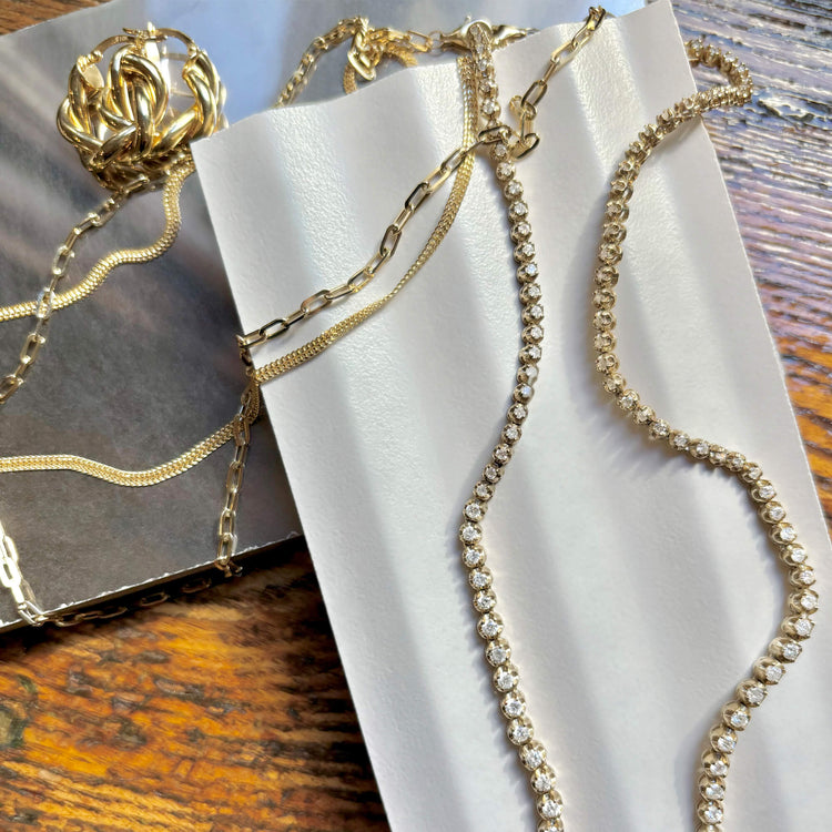 Still life image of In A Twist Gold Hoops with Stone and Strand solid gold jewelry