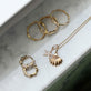 Still life image of Vintage Scallop Shell Necklace with Stone and Strand solid gold jewelry