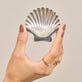 Still life image of Vintage Silver Shell Dish with Stone and Strand solid gold jewelry