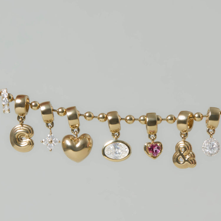 Still life image of Diamond Disco Bead with Stone and Strand solid gold jewelry