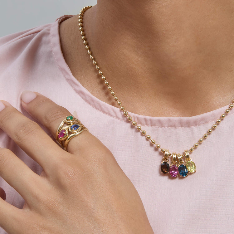 Model wearing Sapphire Raindrop Merge Ring with solid gold Stone and Strand jewelry