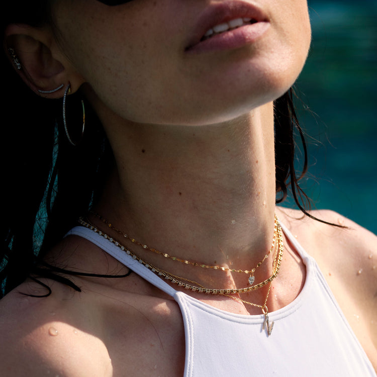 Model wearing Large Pave Diamond Initial Charm Necklace with solid gold Stone and Strand jewelry