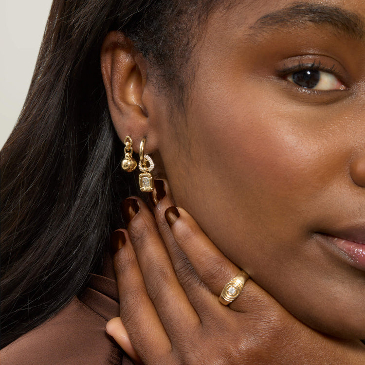 Model wearing Ball Drop Earrings with solid gold Stone and Strand jewelry
