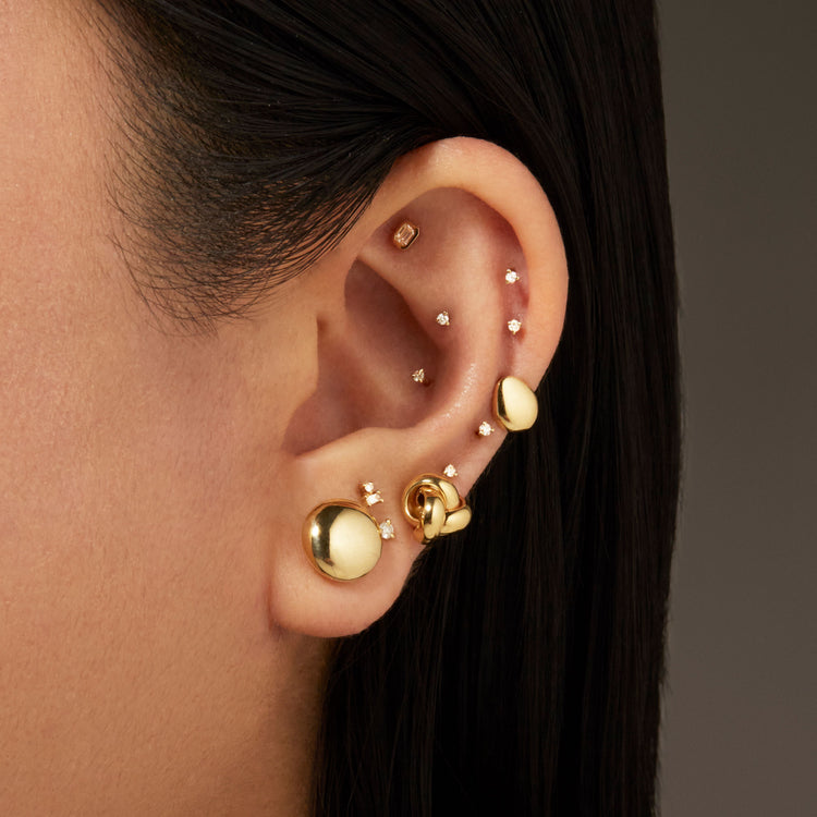 Model wearing Medium Puffed Dome Studs with solid gold Stone and Strand jewelry