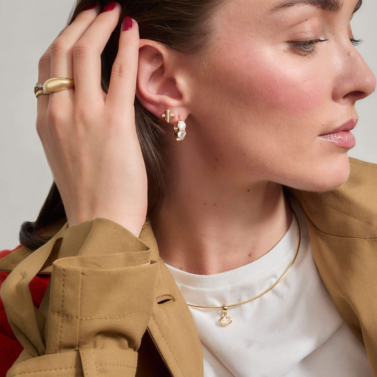 Model wearing Bold Form Ring with solid gold Stone and Strand jewelry