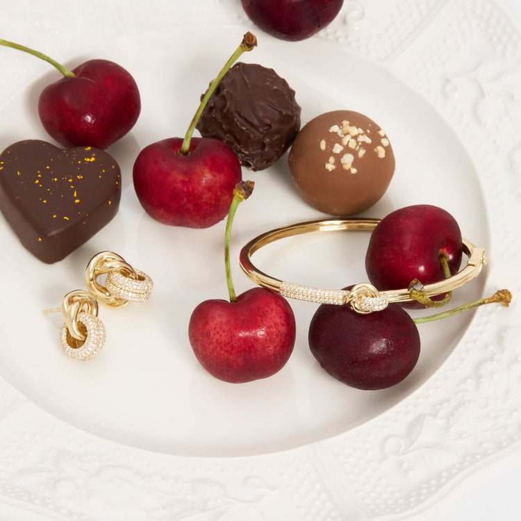 Still life image of Diamond Forme Knot Earrings with Stone and Strand solid gold jewelry