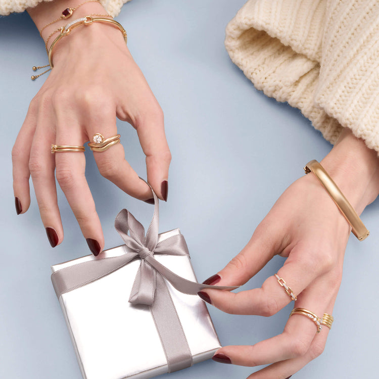 Model wearing Gold Cigar Bangle with solid gold Stone and Strand jewelry
