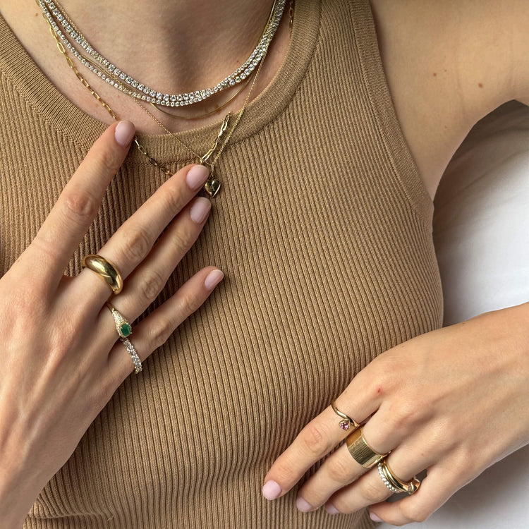 Model wearing Bold Form Ring with solid gold Stone and Strand jewelry