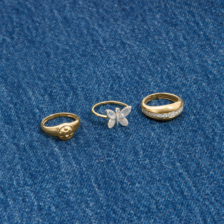 Still life image of Puff Puff Button Initial Ring with Stone and Strand solid gold jewelry