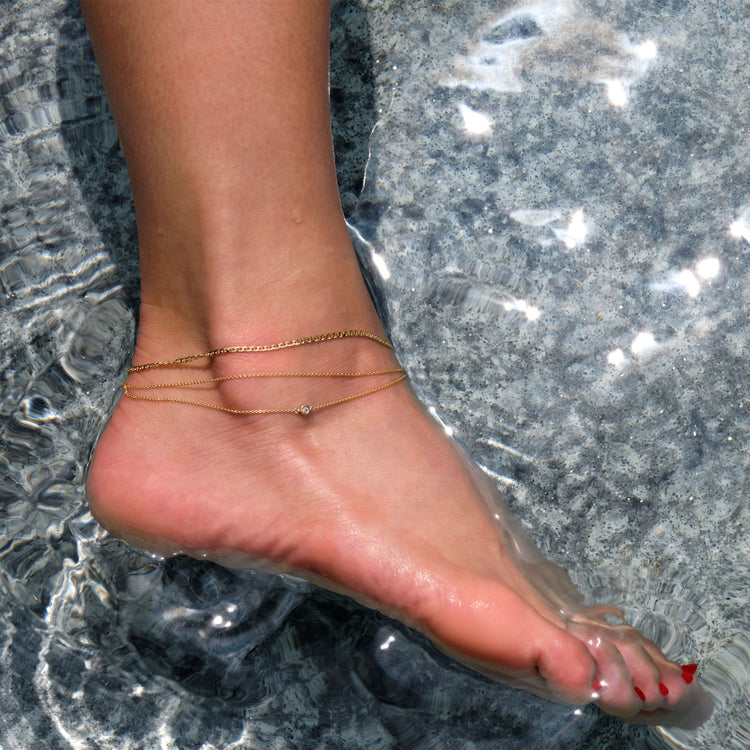 Model wearing Maritime Anklet with solid gold Stone and Strand jewelry