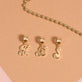 Still life image of Woodstock Initial Charm with Stone and Strand solid gold jewelry