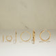 Still life image of Tiny Beaded Huggies with Stone and Strand solid gold jewelry