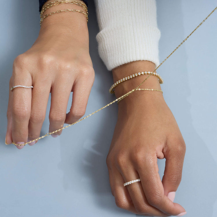 Model wearing Grand Slam Tennis Bracelet with solid gold Stone and Strand jewelry