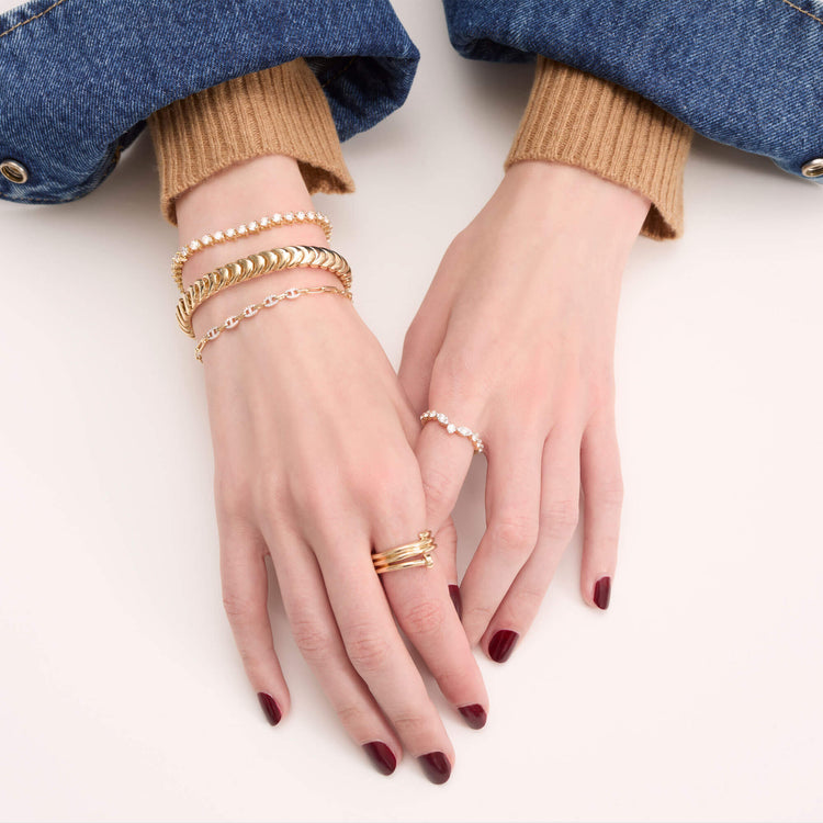 Model wearing Gold La Scala Bracelet with solid gold Stone and Strand jewelry