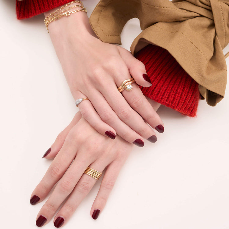Model wearing Five Golden Rings with solid gold Stone and Strand jewelry