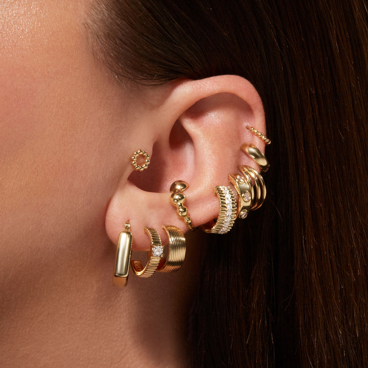Model wearing Squared Off Hoops with solid gold Stone and Strand jewelry