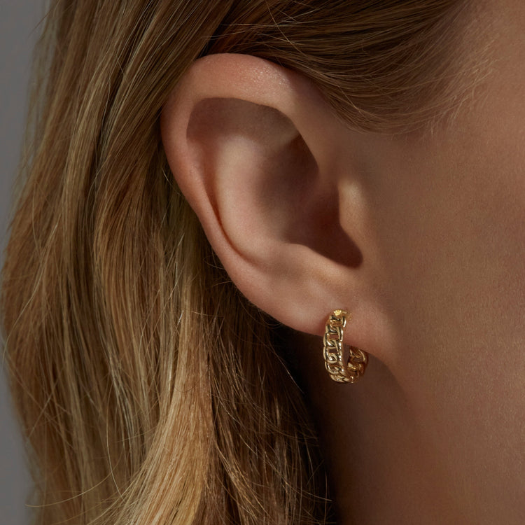 Image of 10K Yellow Gold Dainty Curbside Huggies on Models Ear