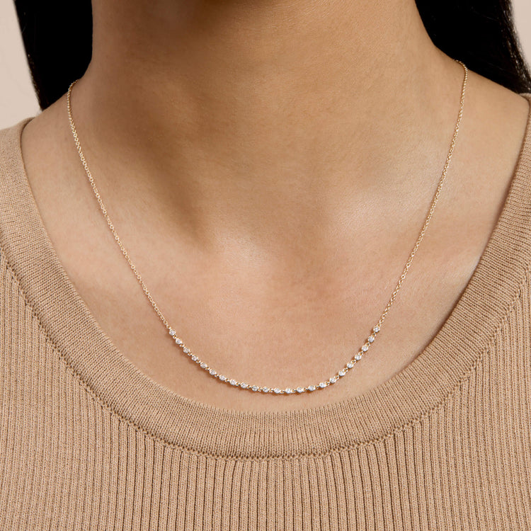 Image of 10K Yellow Gold Teeny Diamond Rally Tennis Necklace on Models Neck