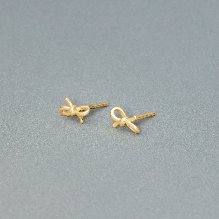 Stone and Strand 10K Yellow Gold Teeny Gold Bow Studs Editorial Image