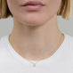 Image of 14K Yellow Gold The Essential Dainty Diamond Solitaire Necklace on Models Neck