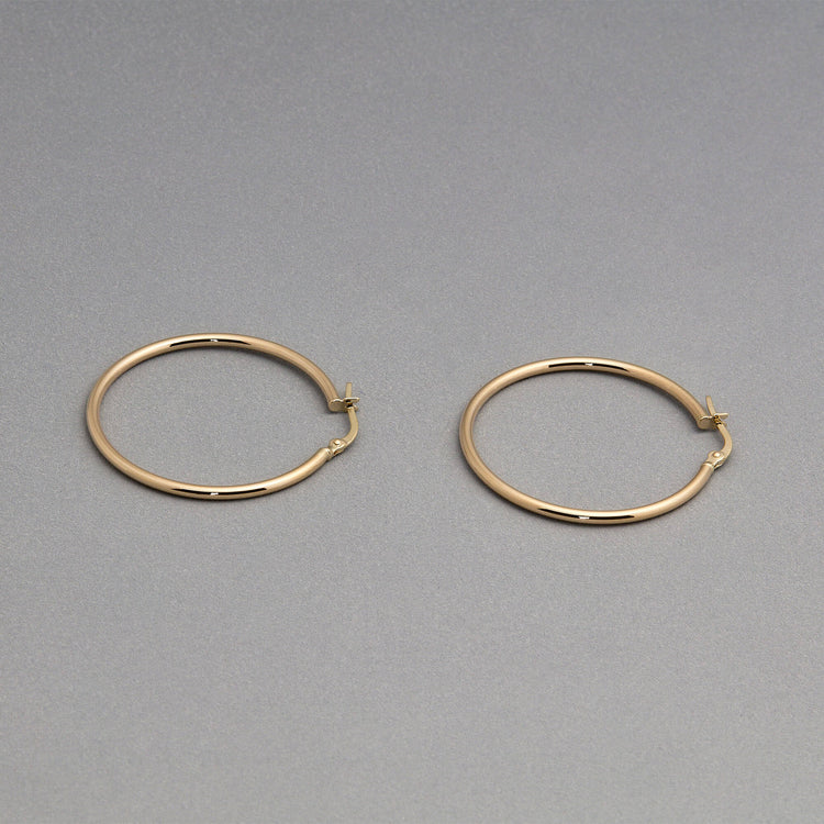 Stone and Strand 14K Yellow Gold Thin Gold Hoops 30mm Editorial Image