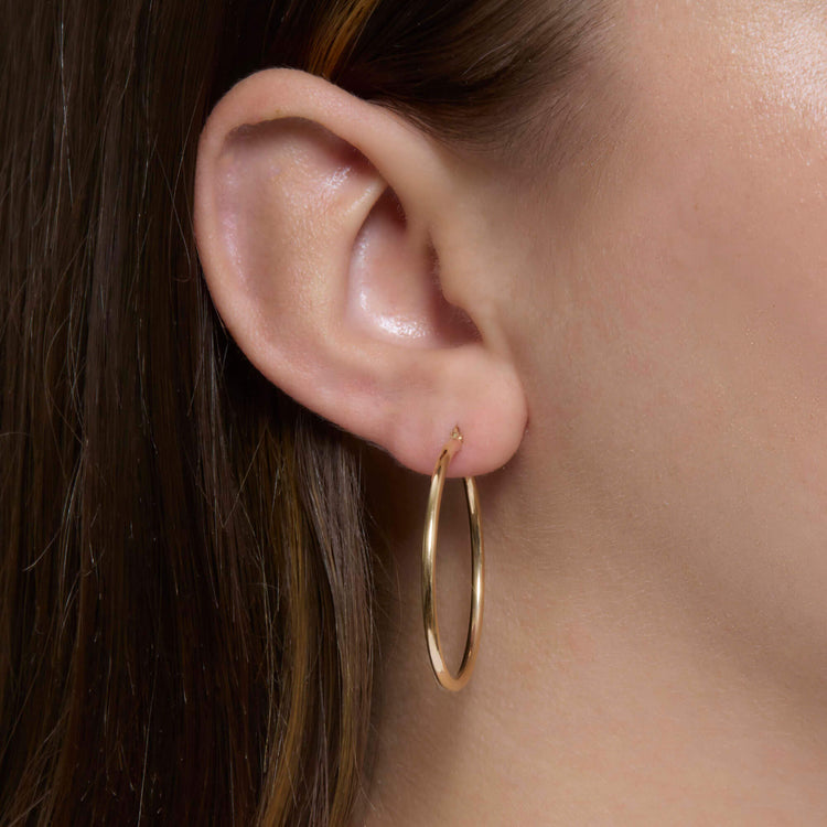 Image of 14K Yellow Gold Thin Gold Hoops 30mm on Models Ear