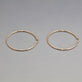 Stone and Strand 14K Yellow Gold Thin Gold Hoops 50mm Editorial Image
