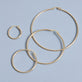 Stone and Strand 14K Yellow Gold Thin Gold Hoops Editorial Image