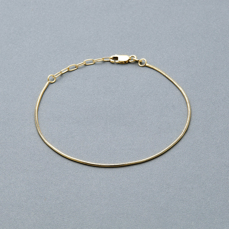 Stone and Strand 10K Yellow Gold Thin Snake Bracelet Editorial Image