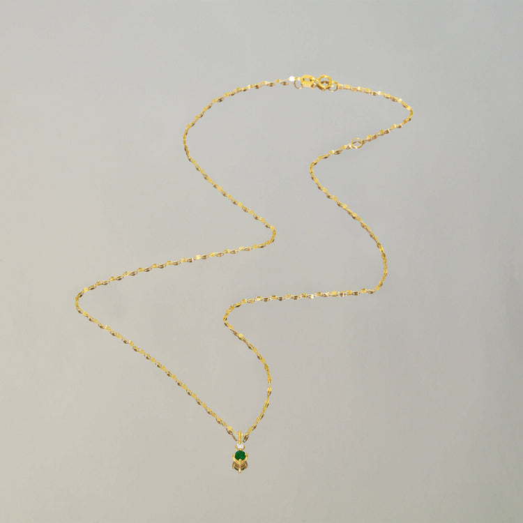 Stone and Strand 14K Yellow Gold Tiny Green Goddess Diamond and Emerald Necklace Editorial Image