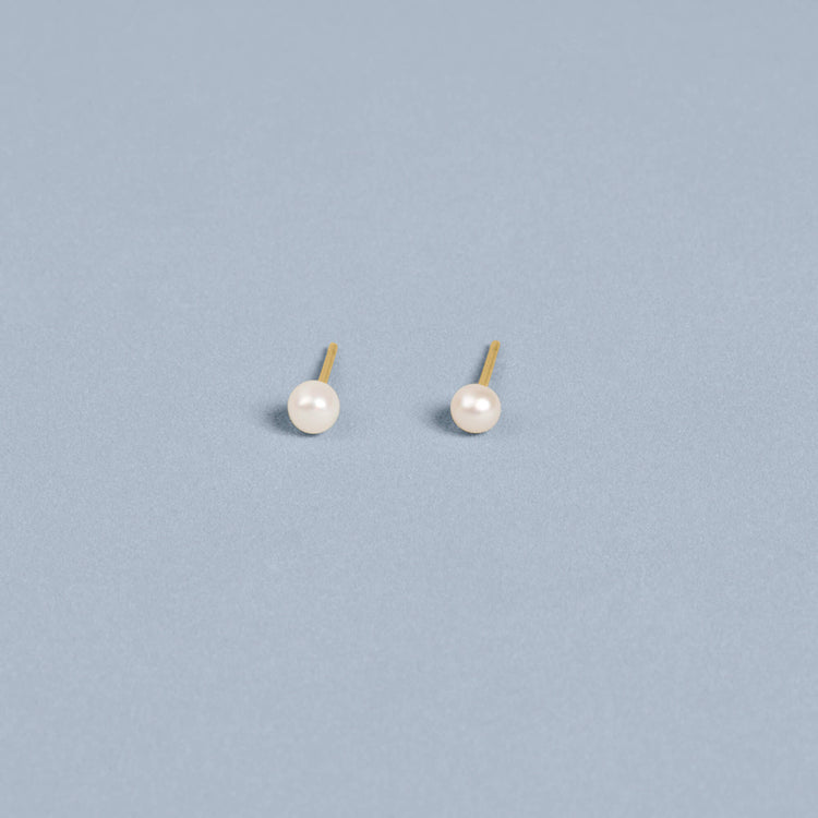 Stone and Strand 14K Yellow Gold Tiny Pearl Earrings Editorial Image
