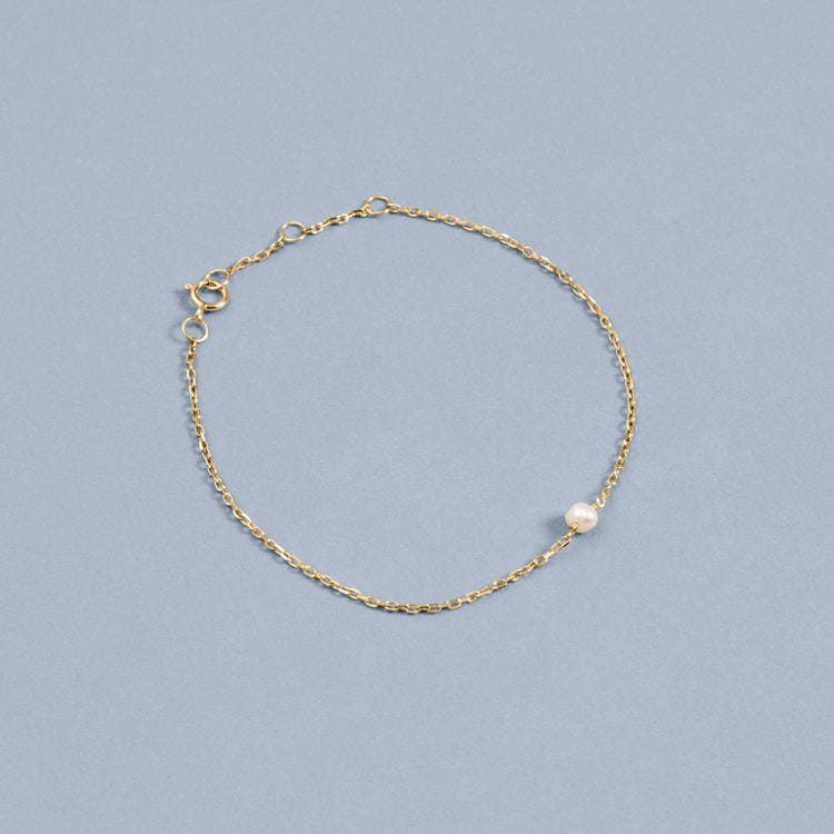 Stone and Strand 10K Yellow Gold Tiny Solitaire Pearl Bracelet Editorial Image