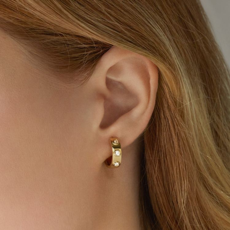Image of 14K Yellow Gold Together Forever Diamond Trio Huggies on Models Ear