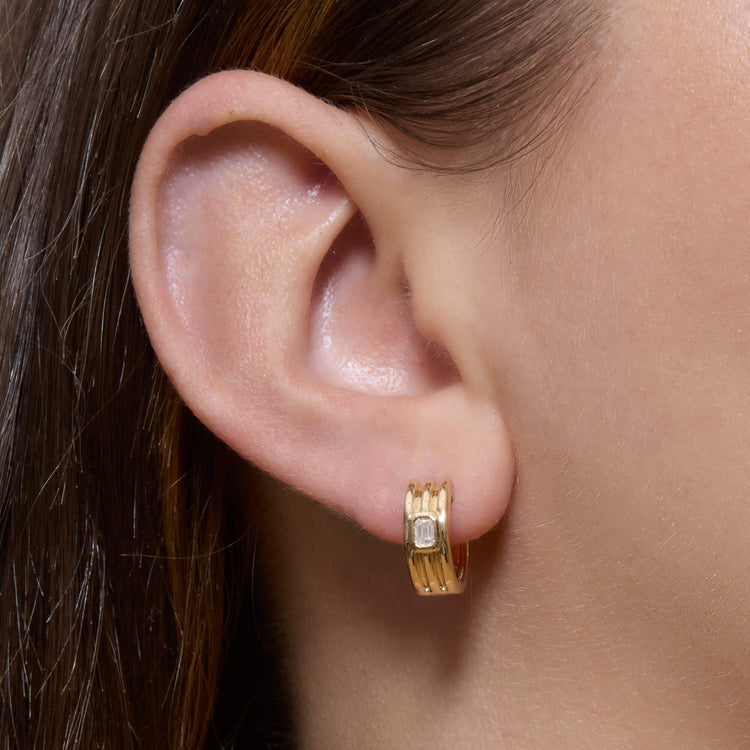 Image of 14K Yellow Gold Trio Ridge Diamond Huggies on Models Ear