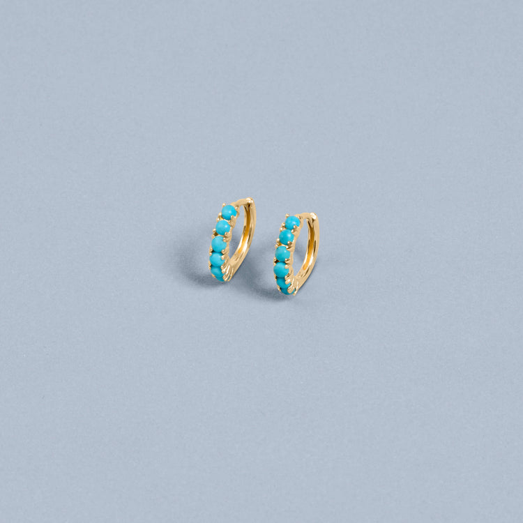 Stone and Strand 14K Yellow Gold Turquoise Huggies Editorial Image