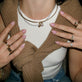 Model wearing Unflippable Tennis Necklace in Yellow Gold with solid gold Stone and Strand jewelry