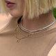 Model wearing Unflippable Tennis Necklace in Yellow Gold with solid gold Stone and Strand jewelry