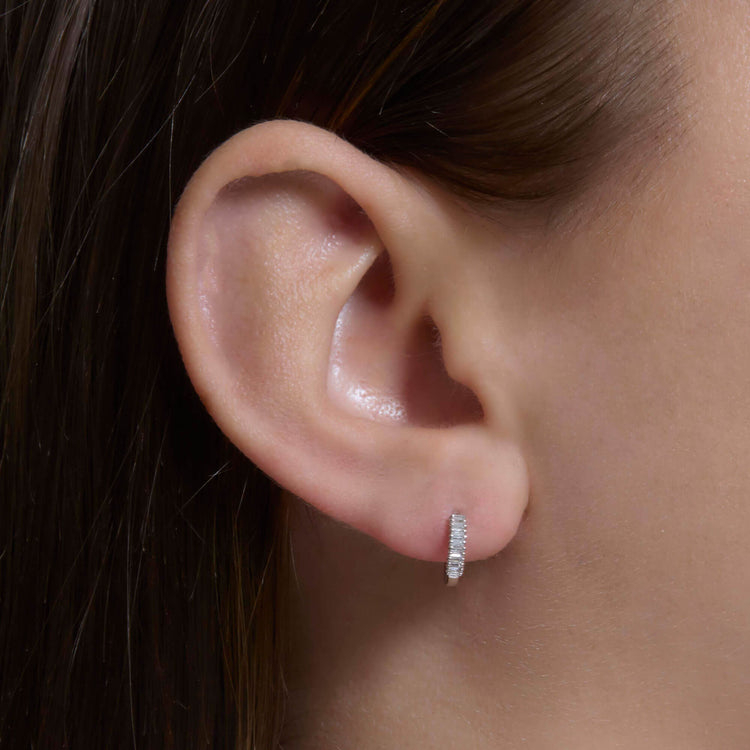 Image of 10K White Gold Dainty Up And Down Baguette Diamond Huggies on Models Ear