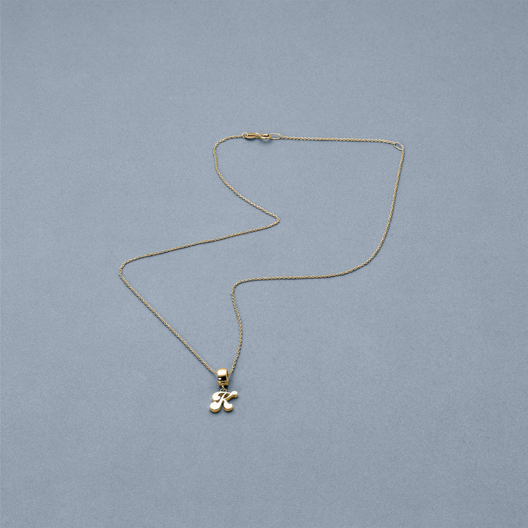 Stone and Strand 14K Yellow Gold Woodstock Initial Charm Necklace Editorial Image