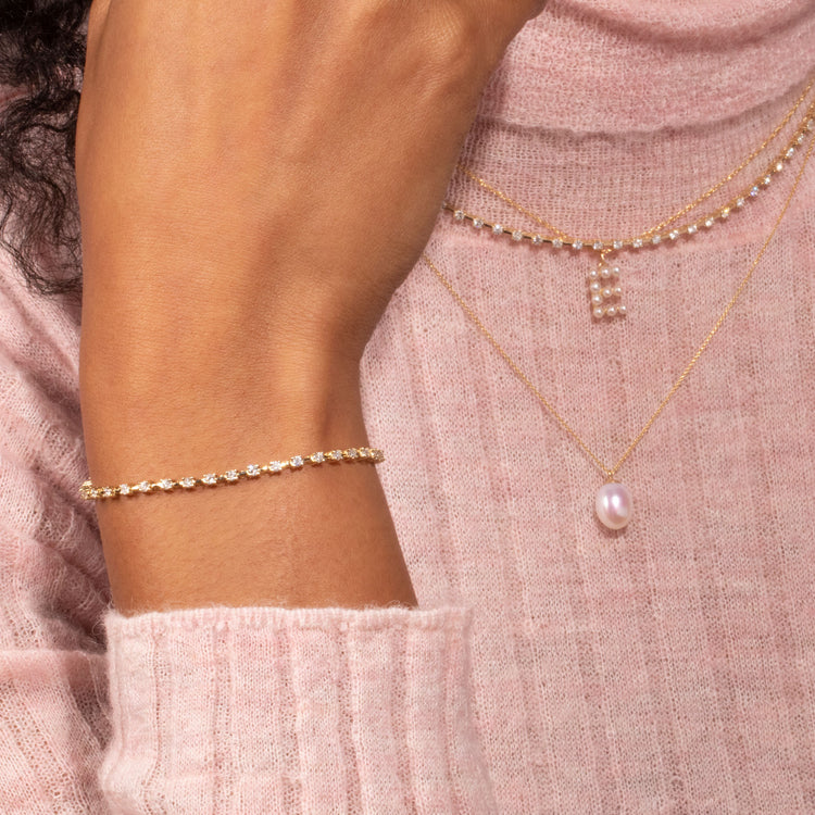 Model wearing Ace Diamond Tennis Bracelet with solid gold Stone and Strand jewelry