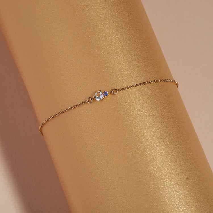 Still life image of Tiny Aquamarine and Sapphire Slider Bracelet with Stone and Strand solid gold jewelry