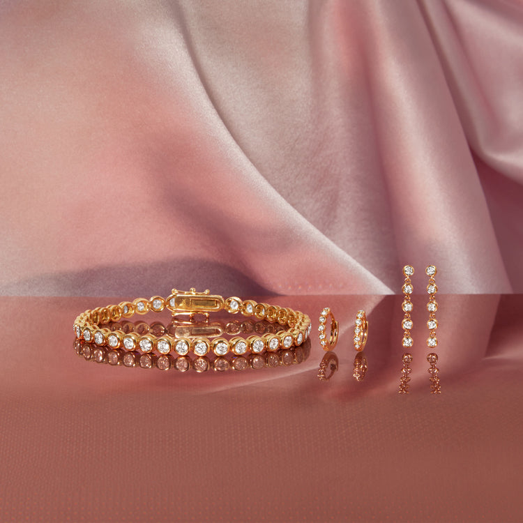 Still life image of Image of Bezel Diamond Huggies with Stone and Strand solid gold jewelry